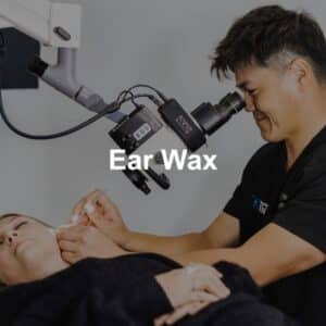 Dr. Yeung cleaning a patients ear