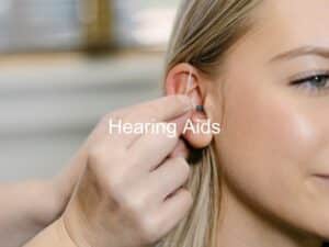 hearing aid being placed into woman's ear
